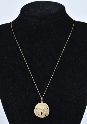 Lot 298 - A yellow metal textured pendant decorated with...
