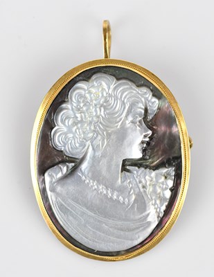 Lot 126 - A carved abalone pendant brooch, profile of a...