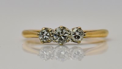 Lot 460 - A yellow gold three stone diamond ring, size M,...