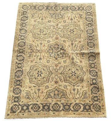 Lot 110 - An Oriental handmade cream ground rug, the...