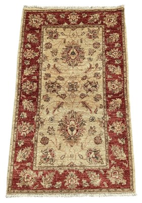 Lot 112 - A modern hand woven Oriental rug, the central...