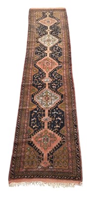Lot 108 - An Oriental hand woven runner, with geometric...