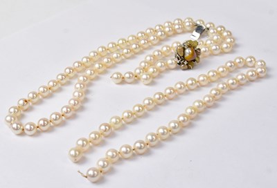 Lot 942 - A double strand pearl necklace, with an 18ct...