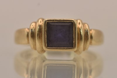 Lot 1335 - A 9ct yellow gold bezel set square cut...