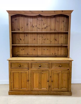 Lot 614 - A large pine farmhouse dresser, with three...