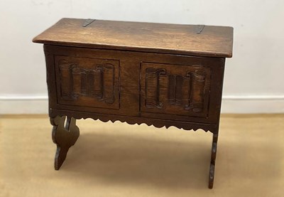 Lot 657 - An 18th century oak chest with carved scroll...