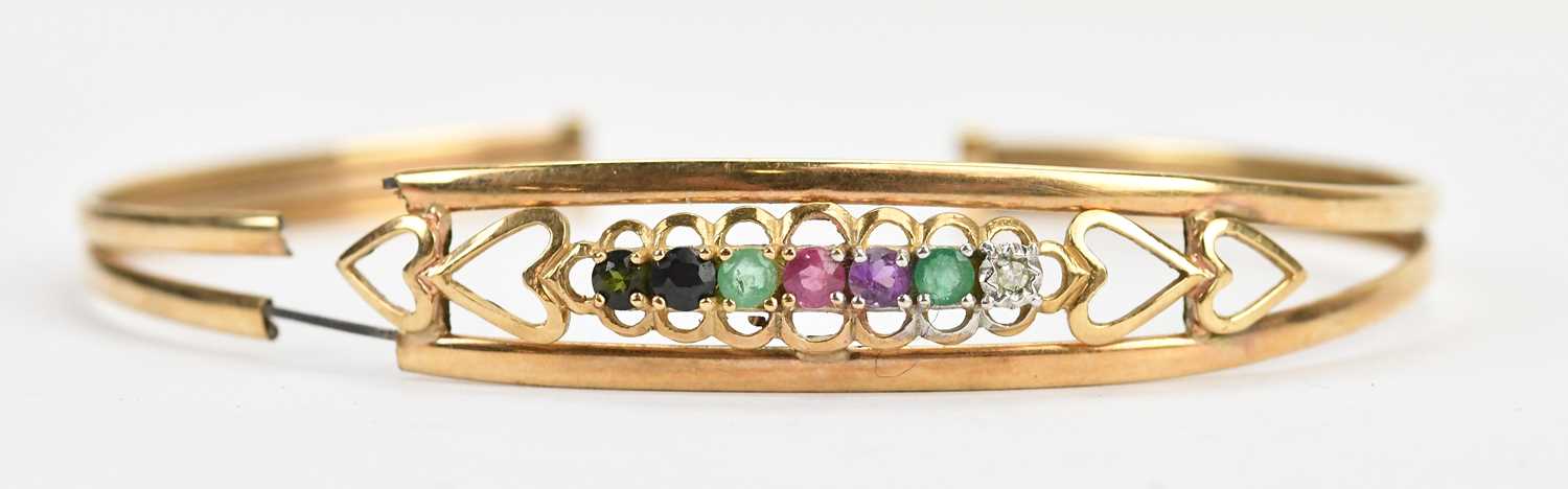 Lot 38 - A yellow metal 'Dearest' bangle set with seven...