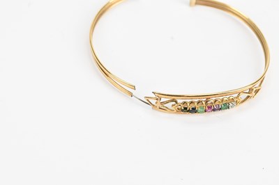 Lot 38 - A yellow metal 'Dearest' bangle set with seven...