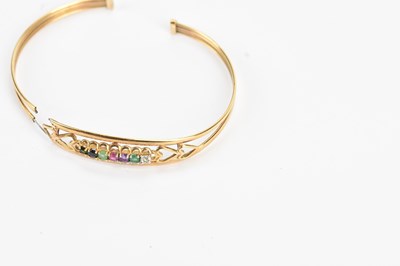 Lot 38 - A yellow metal 'Dearest' bangle set with seven...