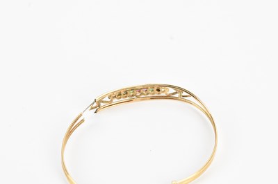 Lot 38 - A yellow metal 'Dearest' bangle set with seven...