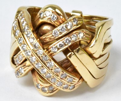 Lot 873 - A yellow metal knot-shaped ring set with...