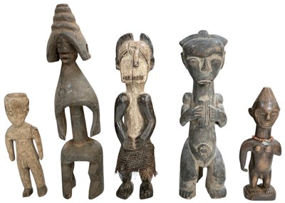 Lot 1017 - Five African carved wooden tribal figures,...