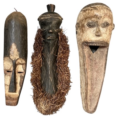 Lot 1023 - Three African tribal carved wooden masks,...