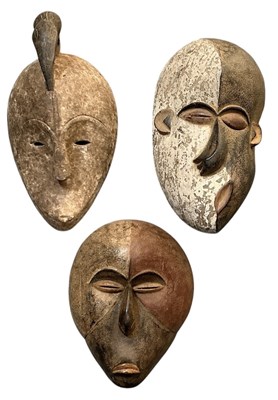 Lot 1024 - Three African tribal carved wooden and painted...