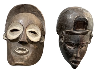 Lot 1025 - Two African tribal carved wooden masks,...
