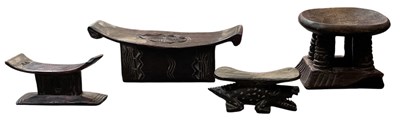 Lot 1005 - Three African tribal carved wooden headrests,...