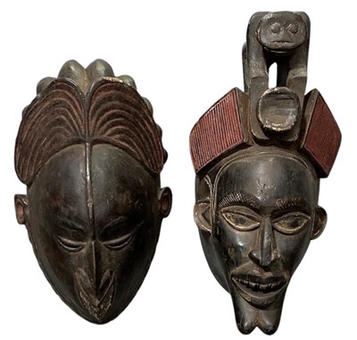 Lot 1029 - Two African carved wooden tribal masks,...