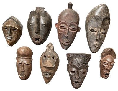 Lot 1007 - Eight assorted African carved wooden tribal...