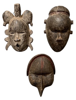 Lot 1026 - Three African tribal carved wooden masks,...