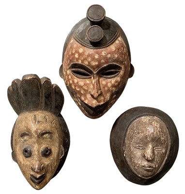 Lot 1027 - Three African tribal carved wooden masks,...