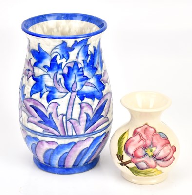 Lot 1599 - MOORCROFT; a squat vase decorated in the...