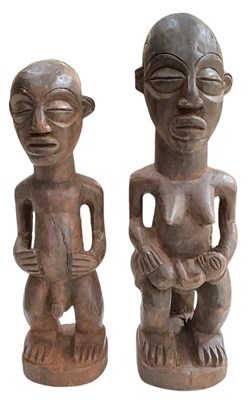 Lot 1030 - A pair of African carved wooden tribal...