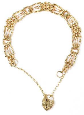 Lot 906 - A 9ct yellow gold four-bar gate link bracelet...