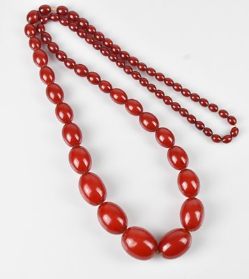 Lot 263 - A cherry amber coloured beaded necklace,...