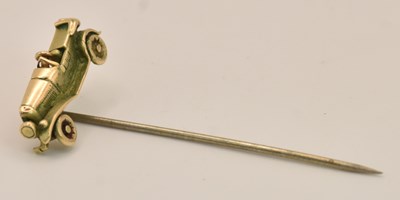 Lot 1271 - A 9ct yellow gold stickpin, surmounted with...