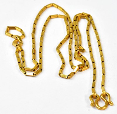 Lot 924 - A yellow metal chain necklace with swirl...