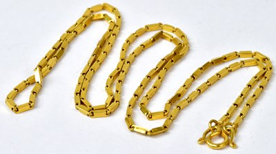 Lot 923 - A yellow metal chain necklace with swirl...