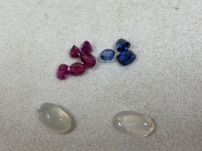 Lot 557 - A group of loose gemstones, including a near...