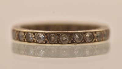 Lot 1342 - A 9ct white gold white stone set full eternity...