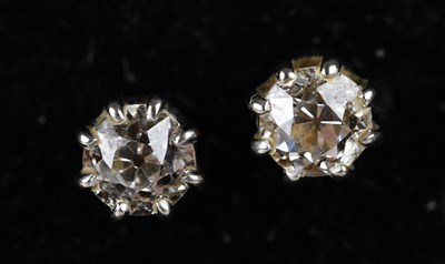 Lot 181 - A pair of diamond solitaire ear studs in white...