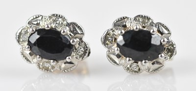 Lot 200 - A pair of diamond and sapphire cluster ear...