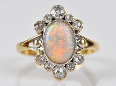 Lot 409 - An 18ct yellow gold diamond and opal cluster...