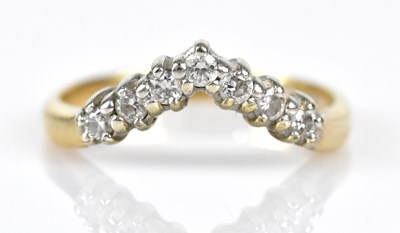Lot 555 - A 9ct yellow gold diamond set wishbone ring,...