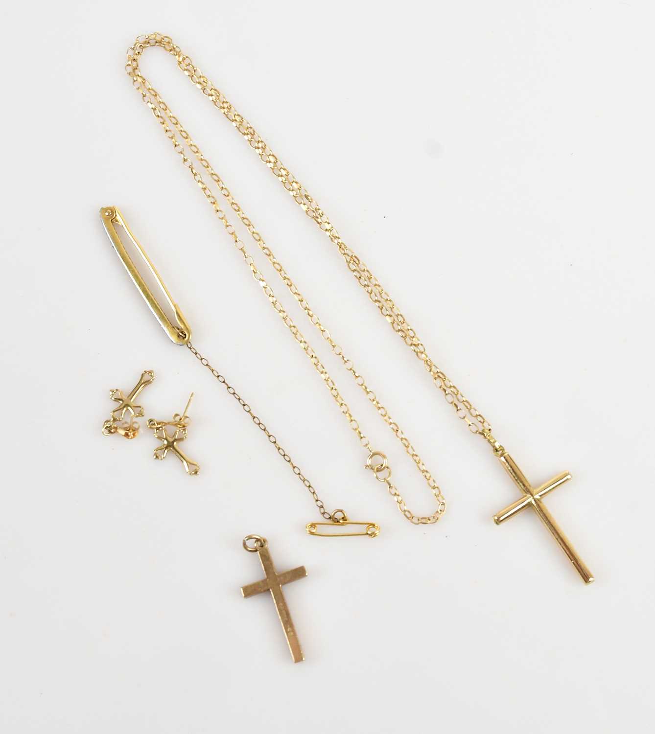 Lot 9 - A 9ct yellow gold cross pendant suspended on a...