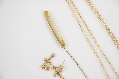 Lot 9 - A 9ct yellow gold cross pendant suspended on a...