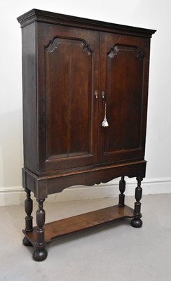 Lot 1154 - An 18th century oak two door cupboard on stand...