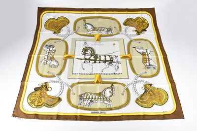 Lot 1253 - HERMÈS; a brown yellow and cream 100% silk...