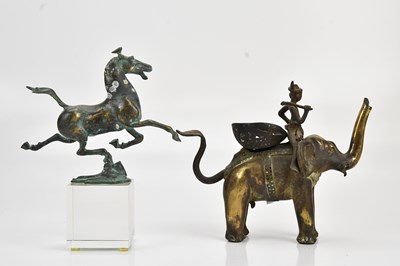 Lot 2148 - An Eastern brass elephant, with a horse on...