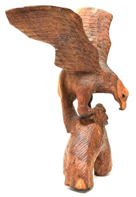 Lot 101 - M. KUDYACHETE; wooden carved eagle on a...