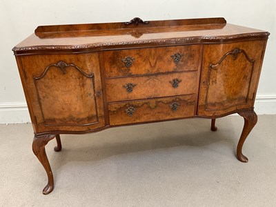 Lot 1105 - A Queen Anne style walnut serpentine sideboard,...
