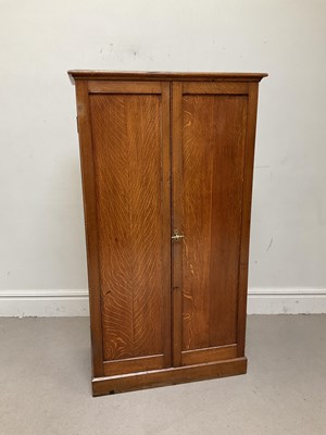 Lot 1083 - An Edwardian oak two door wardrobe, height...