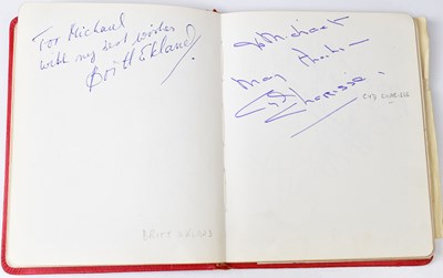 Lot 304 - A vintage red autograph book containing a...