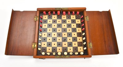 Lot 2098 - A mahogany cased travelling chess set, with...