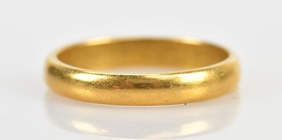 Lot 503 - A 22ct gold wedding band, size N, approximate...