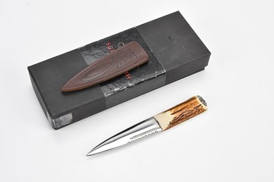 Lot 2110 - A sgian dubh with antler handle and leather...
