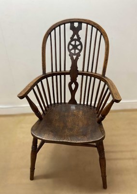 Lot 656 - An oak wheel back farmhouse chair, height 104cm.